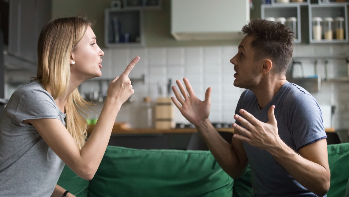 Angry millennial couple arguing shouting blaming each other of problem, frustrated husband and annoyed wife quarreling about bad marriage relationships, unhappy young family fighting at home concept
