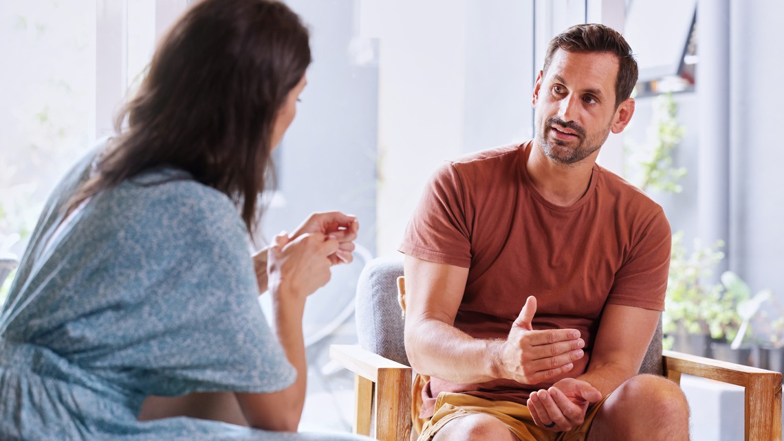 Couple talking in living room
