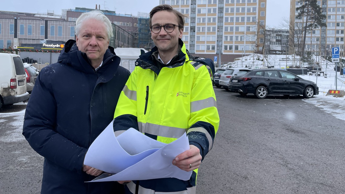 Kommunens projektledare Mats Falås och Robert Nibelius (M) ordförande i tekniska nämnden håller upp en visionsbild av hur platsen kommer att se ut om ett par år.